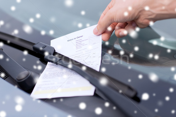 close up of male hand with parking ticket on car Stock photo © dolgachov
