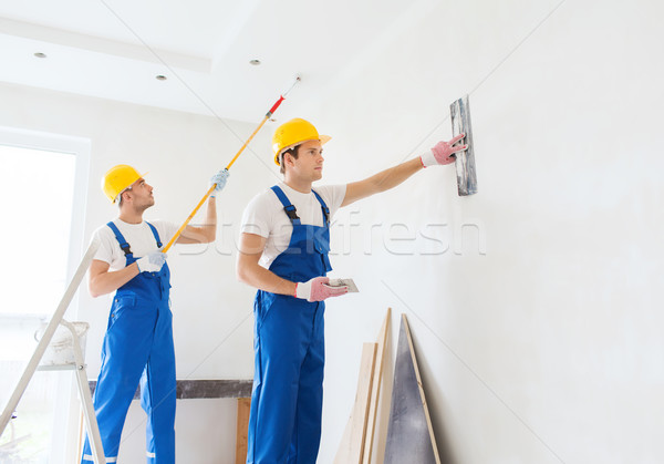 group of builders with tools indoors Stock photo © dolgachov