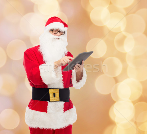 Férfi jelmez mikulás táblagép karácsony ünnepek Stock fotó © dolgachov
