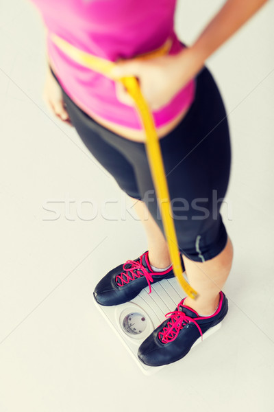 trained belly with measuring tape Stock photo © dolgachov