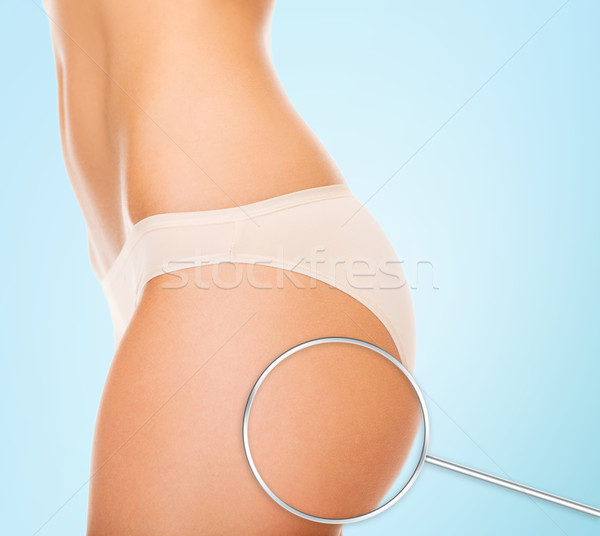 close up of woman buttocks and magnifier Stock photo © dolgachov