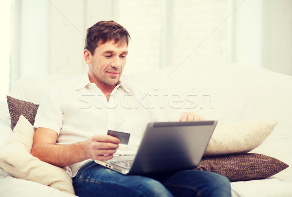 man with laptop and credit card at home Stock photo © dolgachov