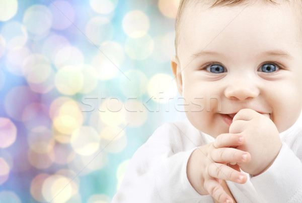happy baby over blue holidays lights background Stock photo © dolgachov