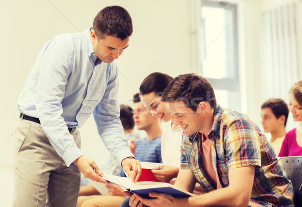 group of students and teacher with notebook Stock photo © dolgachov