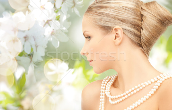 woman with pearl necklace over cherry blossom Stock photo © dolgachov