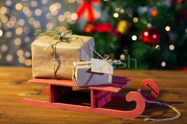 close up of christmas gift boxes on wooden sleigh Stock photo © dolgachov