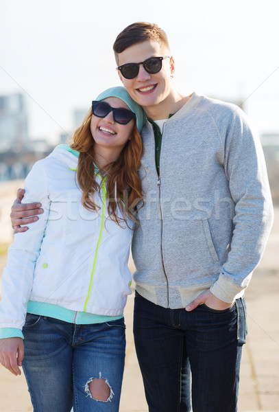 happy teenage couple walking in city Stock photo © dolgachov