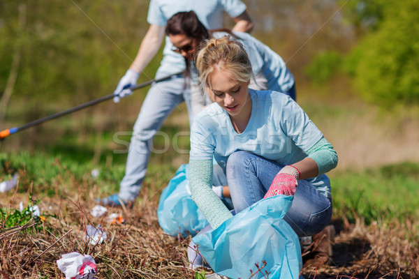 volunteers with garbage bags cleaning park area Stock photo © dolgachov