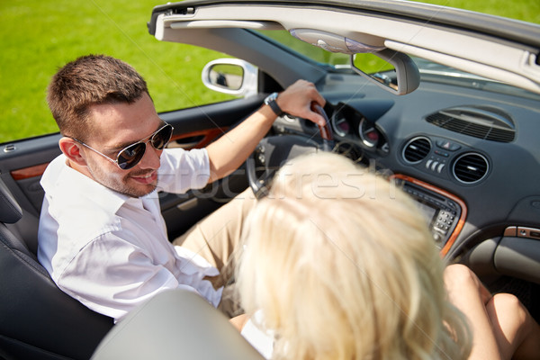 Stock photo: happy man and woman driving in cabriolet car