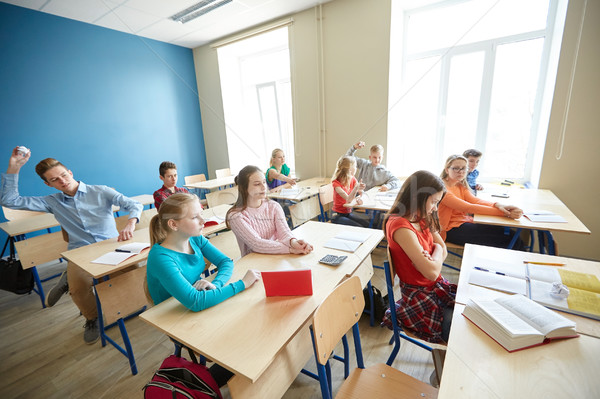 students gossiping behind classmate back at school Stock photo © dolgachov