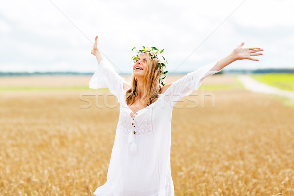 happy young woman in flower wreath on cereal field Stock photo © dolgachov