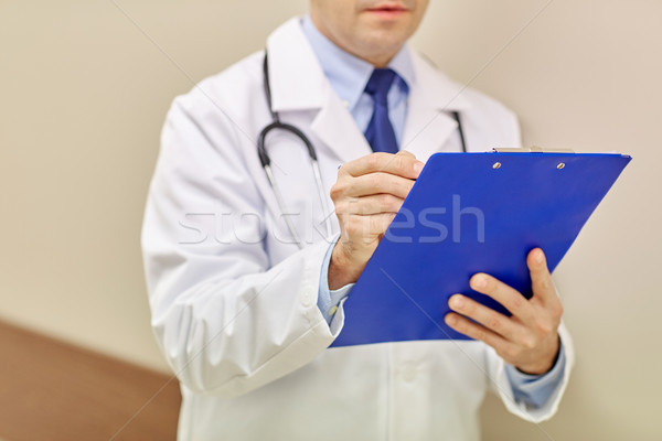 Stock photo: close up of doctor with clipboard at hospital