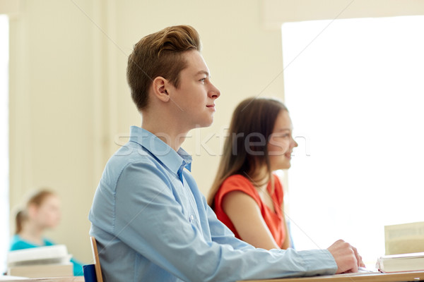 group of students with notebooks at school lesson Stock photo © dolgachov