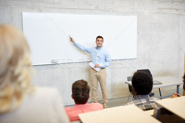 group of students and teacher at lecture Stock photo © dolgachov