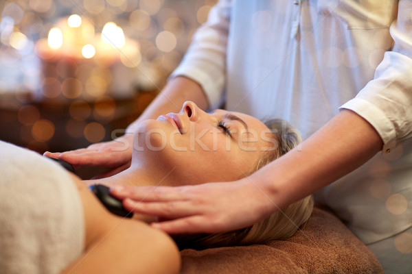 close up of woman having hot stone massage in spa Stock photo © dolgachov