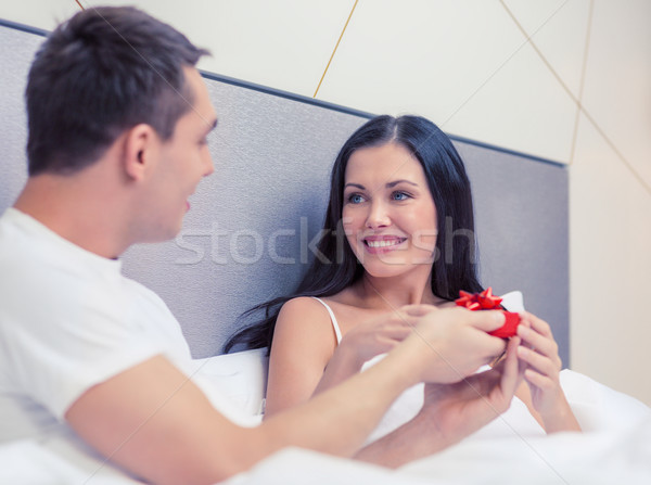 man giving woman little red gift box Stock photo © dolgachov