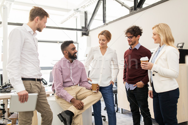 happy business team drinking coffee at office Stock photo © dolgachov