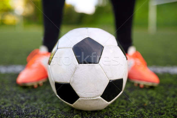 soccer player playing with ball on football field Stock photo © dolgachov
