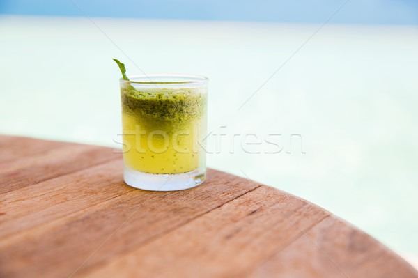 glass with drink or cocktail on bar table Stock photo © dolgachov
