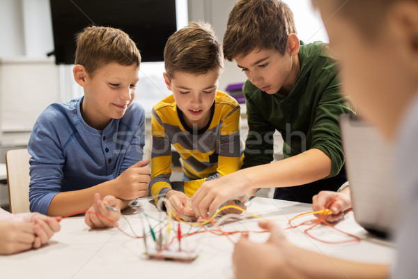happy kids with invention kit at robotics school Stock photo © dolgachov