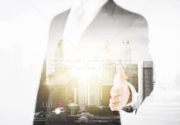 businessman with open hand ready for handshake Stock photo © dolgachov