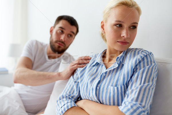 unhappy couple having conflict in bed at home Stock photo © dolgachov