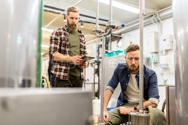 men with tablet pc at craft beer brewery filter Stock photo © dolgachov