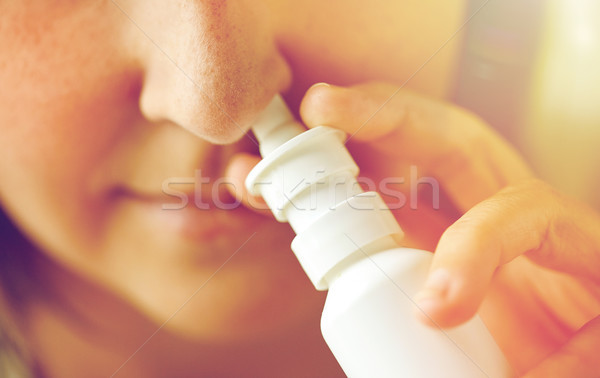 close up of sick woman using nasal spray Stock photo © dolgachov