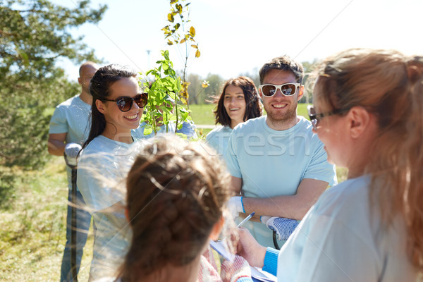 group of volunteers with tree seedlings in park Stock photo © dolgachov