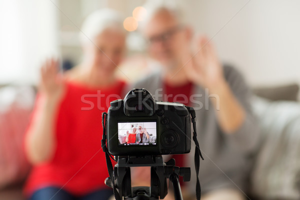 happy senior couple with camera recording video Stock photo © dolgachov