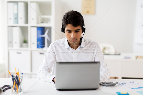 Stock photo: businessman with headset and laptop at office