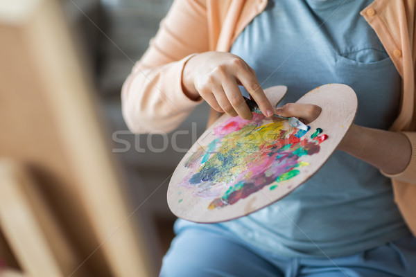 artist with palette knife painting at art studio Stock photo © dolgachov