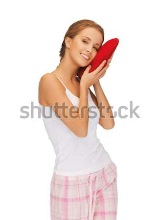 happy and smiling woman with heart-shaped pillow Stock photo © dolgachov