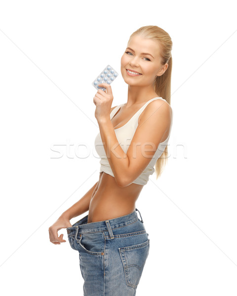 Stock photo: woman with pants and pills