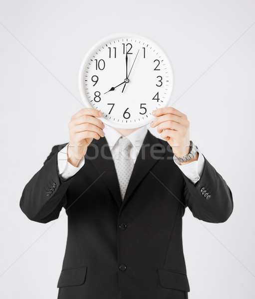man with wall clock Stock photo © dolgachov
