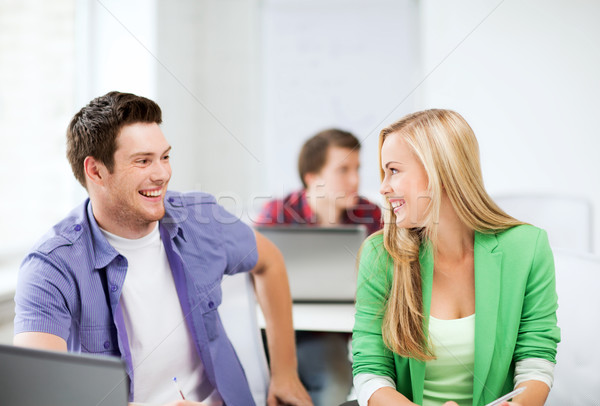 smiling students looking at each other at school Stock photo © dolgachov