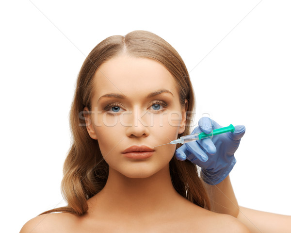 Vrouw gezicht handen spuit cosmetische chirurgie hand vrouw Stockfoto © dolgachov