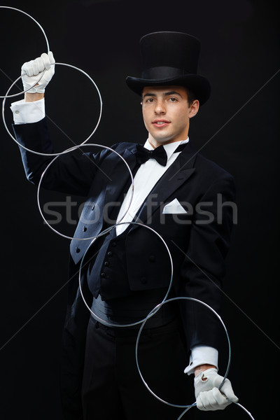 magician showing trick with linking rings Stock photo © dolgachov