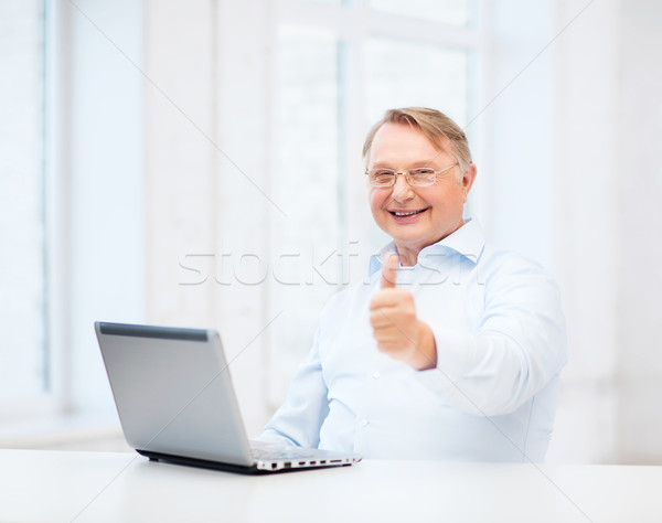 old man with laptop computer showing thumbs up Stock photo © dolgachov