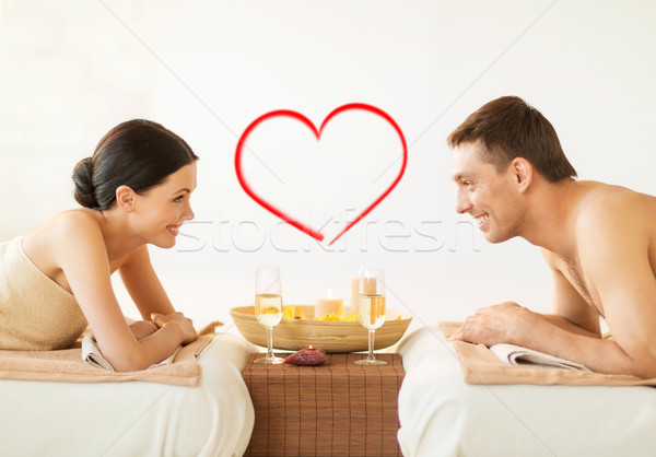 smiling couple with candles and drinks in spa Stock photo © dolgachov