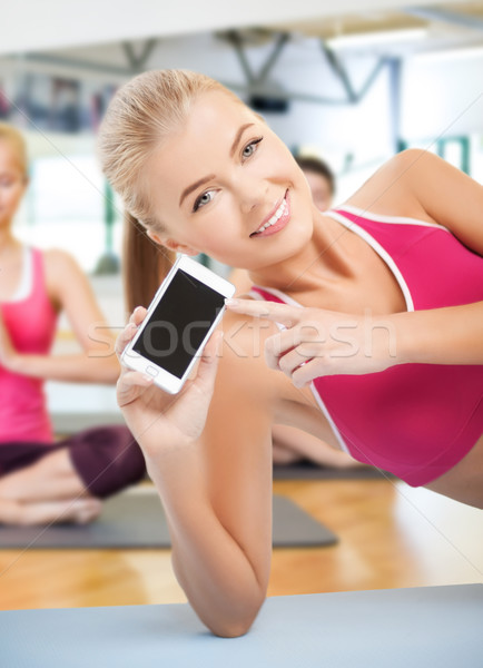 Nő padló okostelefon fitnessz sport képzés Stock fotó © dolgachov