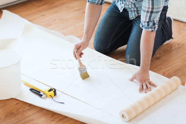 closeup of male hands smearing wallpaper with glue Stock photo © dolgachov