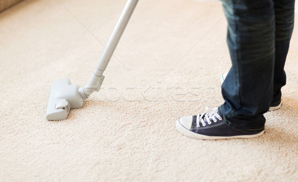 close up of male hoovering carpet Stock photo © dolgachov