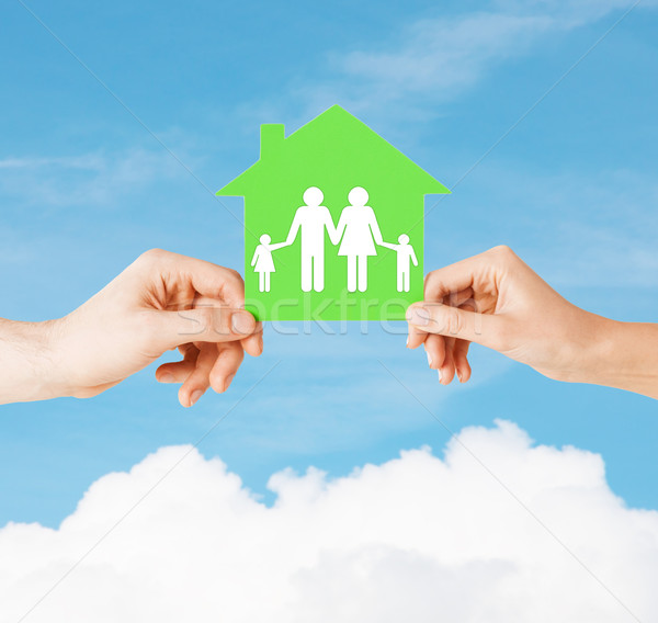 hands holding green house with family Stock photo © dolgachov