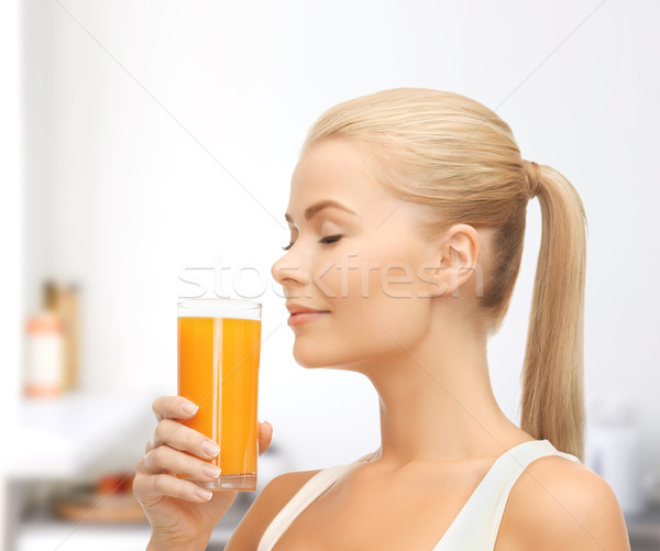 Stock photo: young woman drinking orange juice