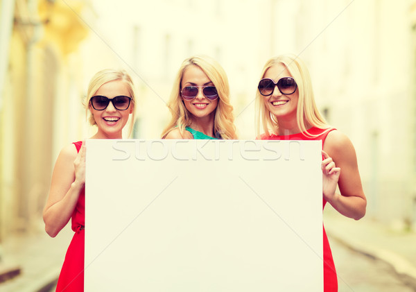three happy blonde women with blank white board Stock photo © dolgachov