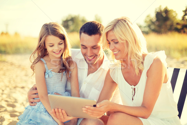 smiling family at beach with tablet pc computer Stock photo © dolgachov