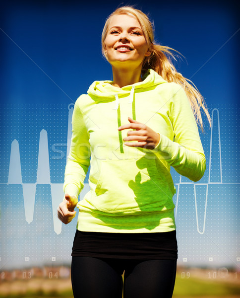 smiling woman jogging outdoors Stock photo © dolgachov