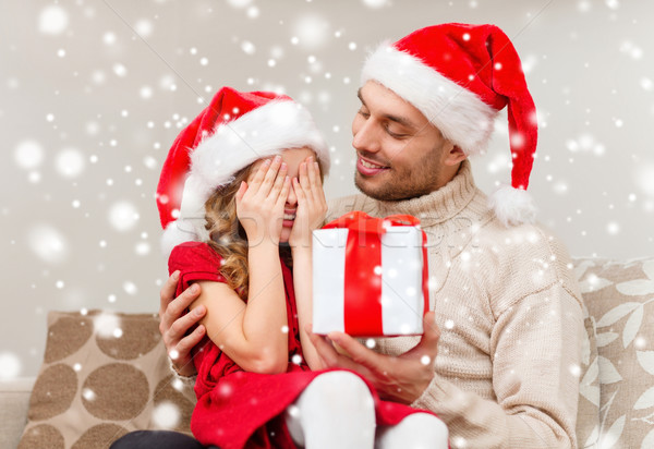 smiling father and daughter holding gift box Stock photo © dolgachov