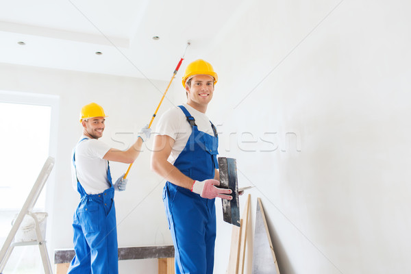 group of builders with tools indoors Stock photo © dolgachov